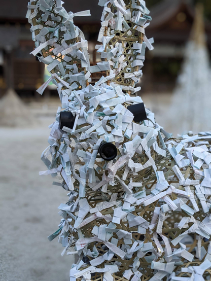 Fortune slips left by the faithful at Kamigamo-jinja. Here they have been folded onto a rabbit shaped frame (celebrating the Year of the Rabbit).