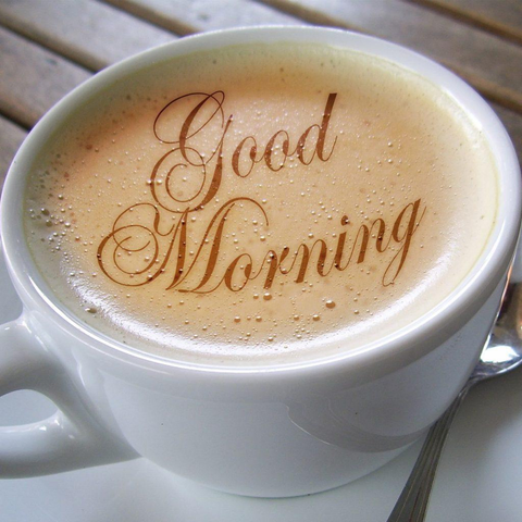 coffee mug that is white with beige coffee in it and reading Good morning