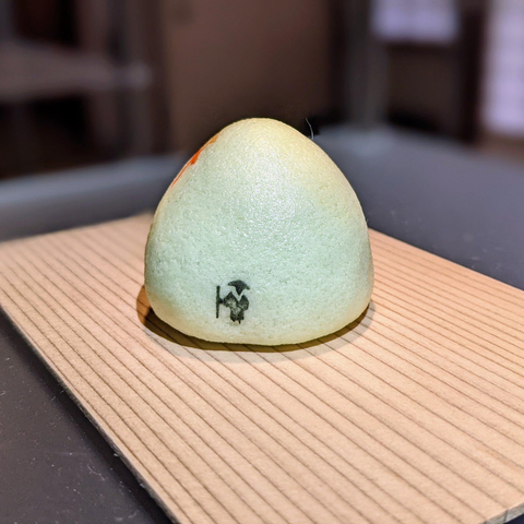 A small pilgrim walks along the base of this unusual sweet.