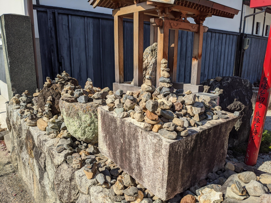 Stones are piled into small towers at a shrine in Arashiyama. Traditionally the souls of children and babies would build such towers after cross the 'River of Three Crossings' as penance.