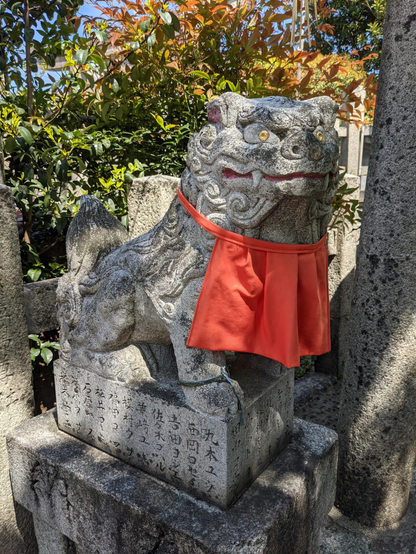 A red bibbed Komainu.