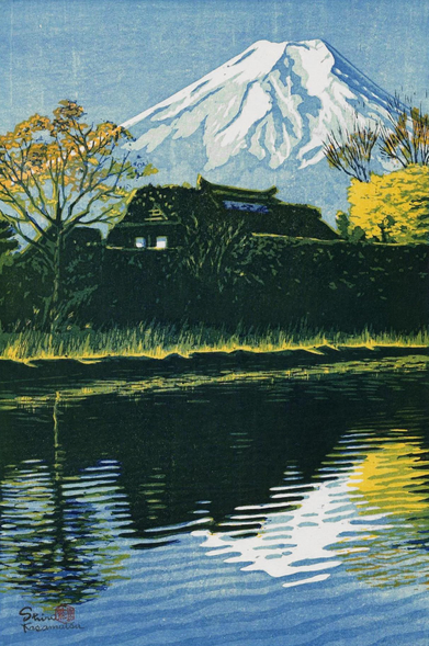 A clear autumn day, looking toward a snow-capped Mount Fuji. In the foreground, a slow-moving river flows past; on the opposite bank, a high wall conceals all but the upper floor of a traditional thatched-roof house. Nearby, trees and grasses are golden yellow with the turning season. Further on, Mount Fuji dominates the view, its snowy peak reflected in the river below.