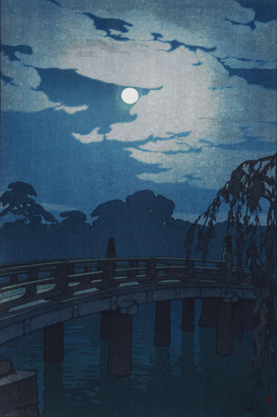 A full moon shines down on Tokyo's Hirakawa Bridge. The traditional wooden bridge spans the inner moat at Edo Castle in a graceful arc; the water below is calm and still, while beyond, the shadows of trees obscure the horizon. The bridge is deserted at this time of night. Above, a bright full moon shines in a starless night sky, illuminating tattered clouds as they slide by.