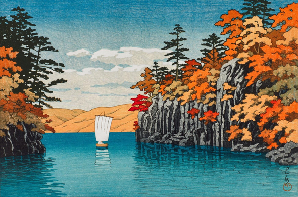 A little wooden lug-rigged sailboat navigates between rocky outcrops on Lake Towada. The rocks are covered with trees rusting red, yellow, and orange with the season. Beyond, on the far side of the lake, low hills are covered in yellowing foliage. The surface of the lake is calm, reflecting the boat and the rocks; above, a few puffy clouds hug the horizon as they cross the bright blue sky.