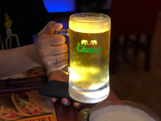A beer mug with a phone acting as a flashlight underneath.