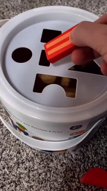 Infamous TikTok video of a man putting all the shapes for a bucket through the square hole. First we have a rectangle that does go through the square hole, then he holds a cylinder, hovers over the circular hole, before putting it in the square hole.