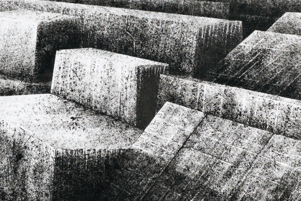 Black and white ink drawing depicting a volcanic landscape where the rocks appear both artificial and natural at the same time.