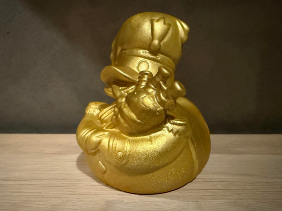 A gold coated rubber duck playing bagpipes — the first prize given in TRSAC 2025’s Freestyle Graphics Competition.