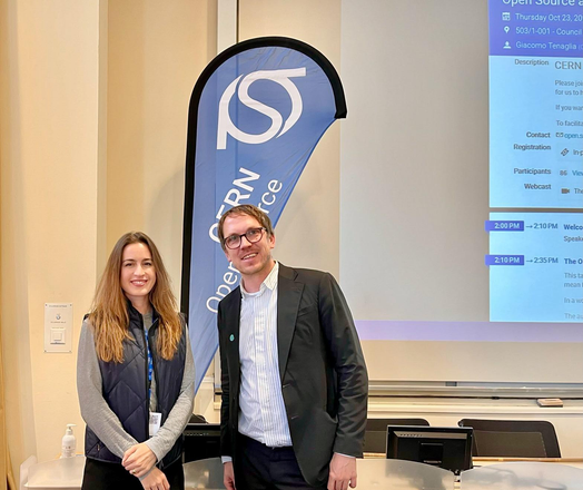 Adriana Groh and Leonhard Kugler (ZenDiS) posing in front of a CERN Open Source banner.