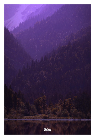False-color forest reflecting in a mountain lake during early morning