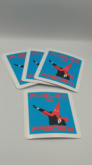 A large 4" square sticker reading in the Tesla motors font: Fueled by Fascism. In the centre is a twist one elon musk throwing a seig hiel on live TV. He's wearing an inverted Tesla T logo over his head like a hood. White eyehole cutouts make the sharp point of the logo look exactly like a KKK pointy hat for losers. 