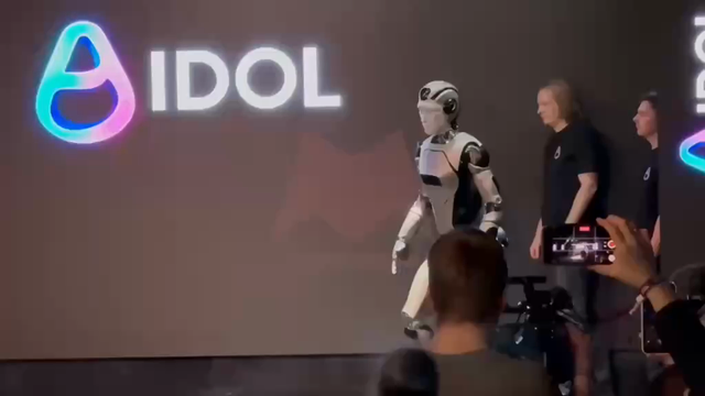 Robot failing to walk, falling to the ground, while company attempts a cover-up.