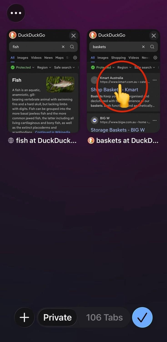 a screenshot of the Safari mobile browser in iOS 26 showing the tab picker screen – two tabs are visible, one is a DuckDuckGo search result page for the word “fish”, the other is a DuckDuckGo search result page for the word “baskets” 
 
a large red circle with an emoji of a hand with the index finger extended highlights the middle of the tab on the right (the search for “baskets”) where you tap to switch to the second tab