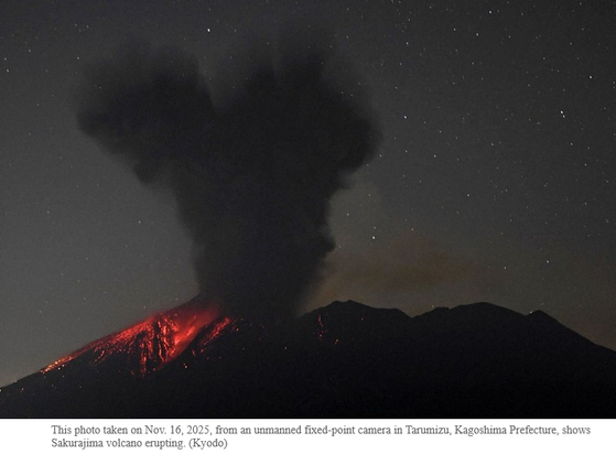 Photograph accompanying Kyodo news article "Sakurajima volcano erupts in southwest Japan, creating 4,400 m-high plume"
A dark plume rises from the top of volcano silhouetted against a star-filled night sky. Red, glowing lava flows down the left side of the volcano.
Caption:
"This photo taken on Nov. 16, 2025, from an unmanned fixed-point camera in Tarumizu, Kagoshima Prefecture, shows Sakurajima volcano erupting. (Kyodo) "