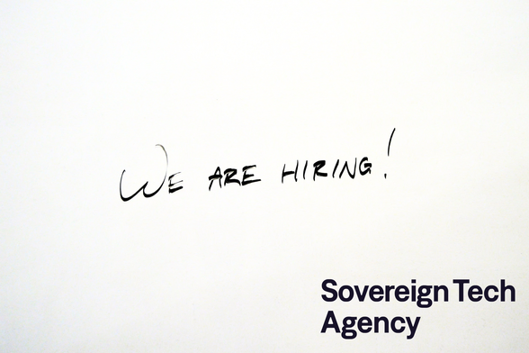 "We are hiring!" on a whiteboard, with the Sovereign Tech Agency logo in the bottom right corner.