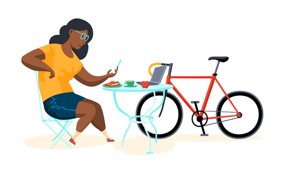 Illustration of a woman of colour with glasses and cyclist outfit sitting at an outside table of a cafe looking at her smartphone. There's an apple, a laptop, a coffee and a sandwich on the table, a racing bike is leaning against it.