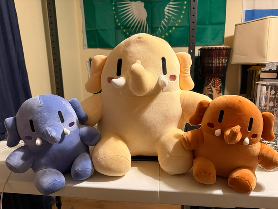 Three Mastodon plushies! Bigger one is in the middle while the two smaller ones are on either side.