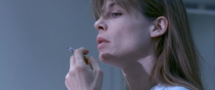 Scene from Terminator 2. Sarah Connor smoking a cigarette, looking very disappointed
