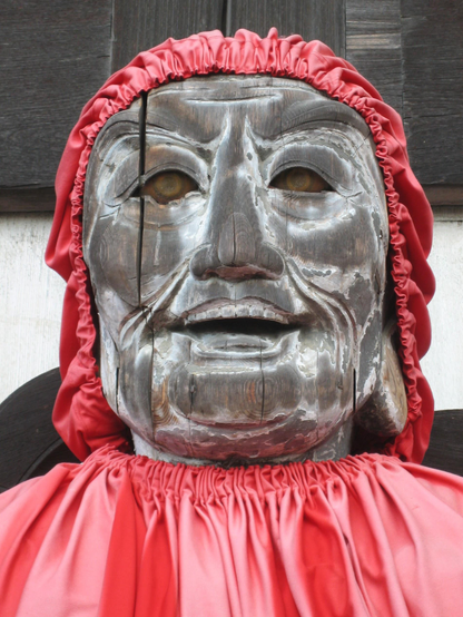 Todai-ji's weathered statue of Binzuru (dressed in a red hood and bib).