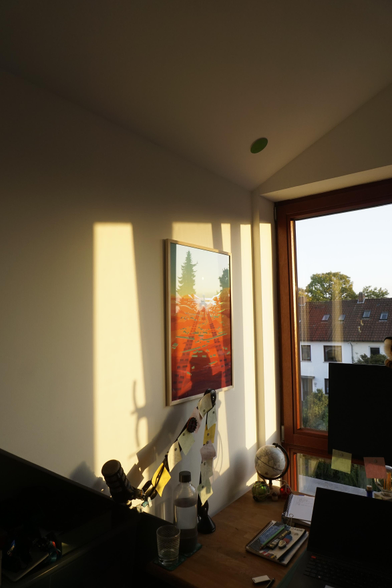 A picture of the curiosity rover poster made by Kurzgesagt on my wall, in the sunlight of the evening.