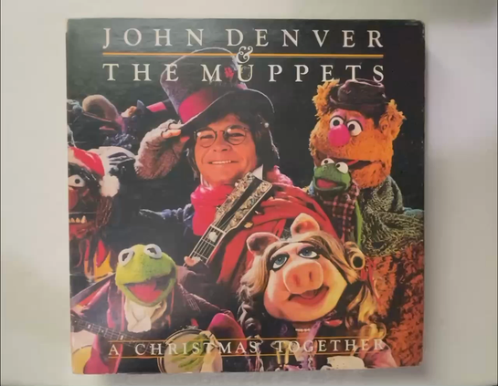 A selection of albums are lifted up by my hands. The very first one is John Denver and The Muppets, and you’ll see other albums by The Beach Boys, Sinatra, and the Chipmunks.