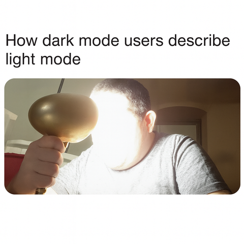 text reads "How dark mode users describe light mode." Image shows a person in a grey t-shirt holding a bright illuminated lamp directly next to their face, the light washing out their features.