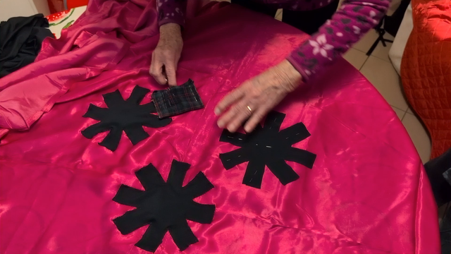 Grandma positioning the third and final asterisk, while some Italian Catholic channel goes in the background.