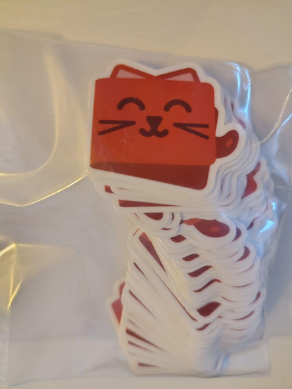 A bunch of little Catima logos stuck in a small sticker bag.

There's 100 of them in there, tightly stacked together, which I would hope is more than enough but we'll see :)