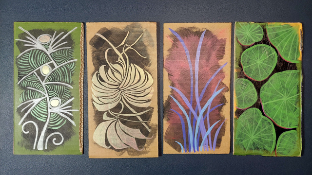 A series of four plant paintings on cardboard. The first is stylised but recognisable as an imaginary plant lifeform. The second could be a lotus or a fan-shaped palm. The third are blades of purple and lilac grass against a black and red background. The last is a top-down view of giant lily pads floating on black water.