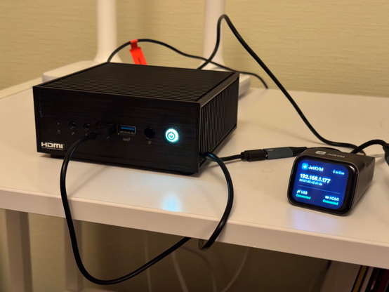 An Asus mini PC with JetKVM connected to it