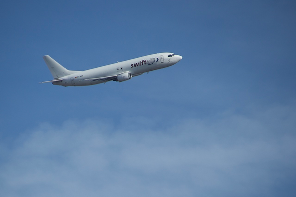 Boeing 737 operated by SwiftAir, in the air.