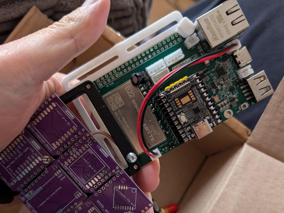 A Femtofox Pro board. A pocket sized circuit board with lots of wires.