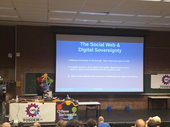 Sandra on stage with a slide 