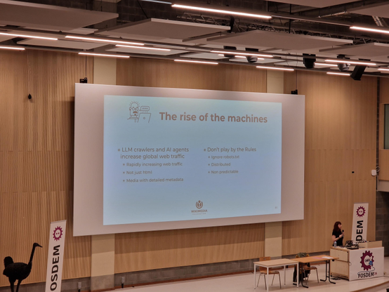 Slide showing "The rise of the machines" describing pain caused by LLM web crawlers to Wikipedia servers.