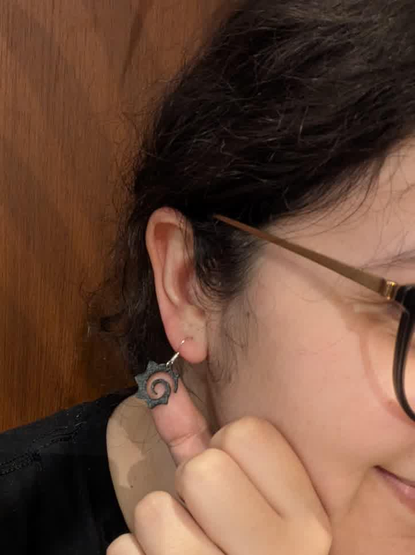 A woman wearing prusa 3D printed Grafana earrings.