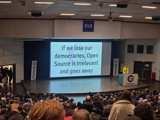 Slide on the main stage with "If we lose our democracies, open source is irrelevant and goes away"