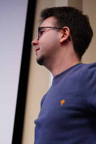 A portrait of Florian listening to his co-speaker