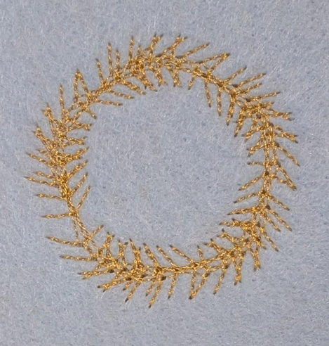 A stitched pattern, it is circular pattern with 'branches' going round the outside and side of the circle. 
