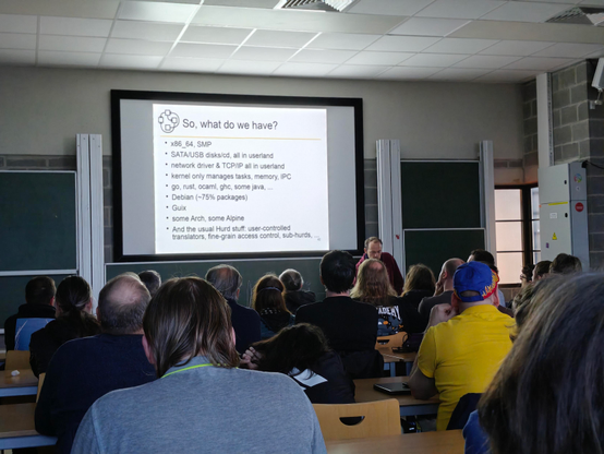  Slide: So, what do we have?

* x86_64 SMP
* SATA/USB disk/cd, all in userland
* netwokr driver & TCP/IP all in userland
* kernel only manages tasks, memory, IPC
* go, rust, ocaml, ghc, some java...
* Debian (~75% packages)
* Guix
* som Arch, some Alpine
* An the usual Hurd stuff: user-controlled translators, fine grain access control, sub-hurds.

