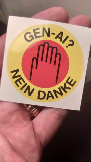 A yellow, red and black circular sticker in the form of the "nuclear power no thanks". This one reads Gen AI? Nein Danke and the logo is a 6 fingered hand. 