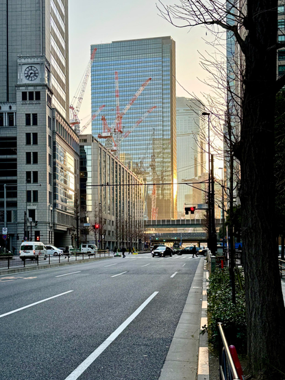 A simple unedited morning scene from the area around Tokyo Station. Sunlight is being reflected off of window panels of high-rise office buildings.