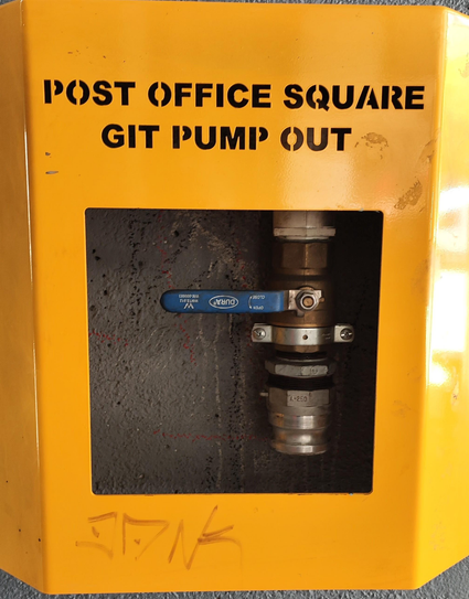 A fire hydrant pump? Stencil font is cut out saying "post office square
Git pump out"