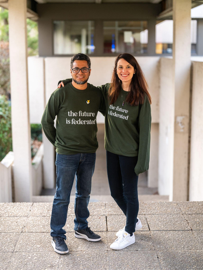 Two people with green sweaters