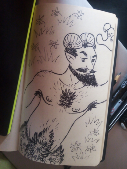 Photo I took from my desk. It's a page of my sketchbook, opened. The drawing, made with black pen, portrait a satyr (or faun) with a pair of goat horns in his head, as expected. He's shirtless and you can see his bearded face with the pointy moustache, hairy torso and the beginning of the thick fur from his goat legs. He's brunette, attractive, and is laying on a field of grass and flowers, with his left arm raised, almost behind his head, in a sensual way, and subtlety looking to the observer.