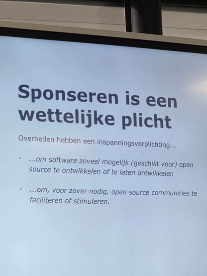 "Sponsoring open source is a legal obligation (for the government)" slide on the main screen.