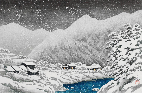 Snow falls on a Japanese mountain village. In the foreground, an icy river cuts through the wintry landscape; on the right-hand bank, tall trees are plastered with snow, while on the left-hand bank, warm lights glow in the windows of a handful of snowed-in houses. Beyond, snow-covered mountains cut a jagged line across dark clouds.
