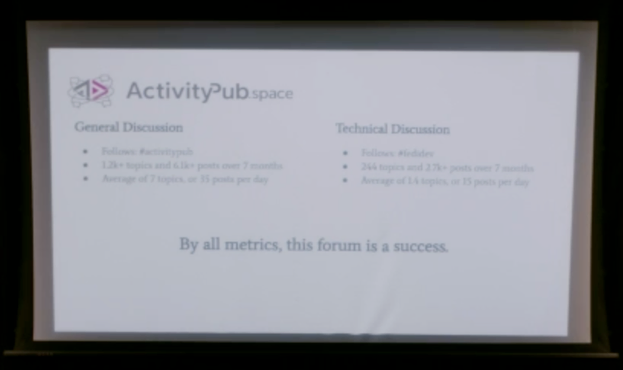 A blurry slide explaining the success of the activitpub forum on NodeBB.