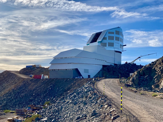 The Vera C. Rubin Observatory is shown in later afternoon light.  

The dome is open and although it is still a construction area (you can see cranes in the image) you can see that the outside of the observatory is near completion.  The shiny aluminum coating on the dome is almost complete in the picture.

I captured this image in November of 2022.