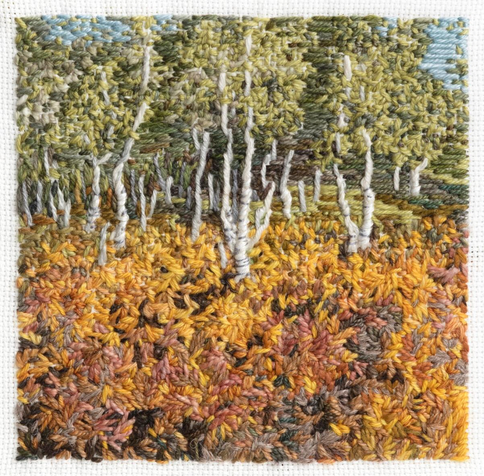 Stitched artwork depicting silver birch trees with autumnal bracken in the foreground