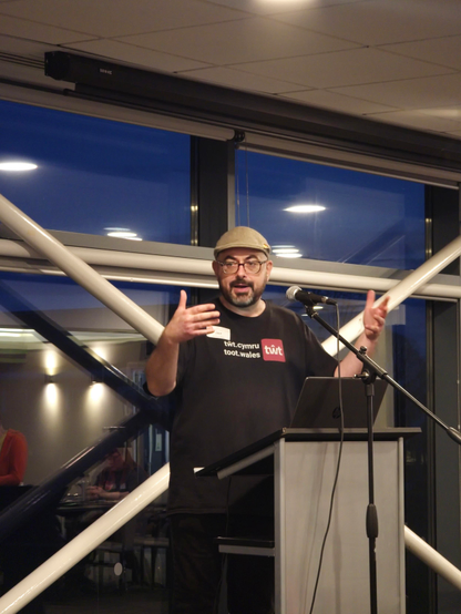 Jaz of twt wales speaking at a lectern